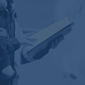 Pilot or aviation worker holding folder and documents on navy-toned background.